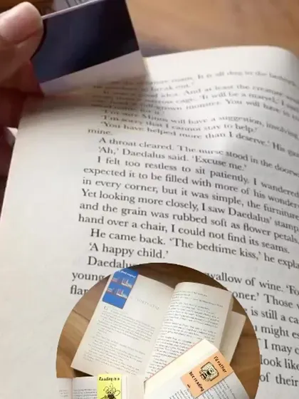 A demonstration of how the magnetic bookmark folds over the page to stay securely in place.