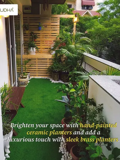 This balcony design uses a mix of textures and materials. Hand-painted ceramic planters add an artistic touch, while sleek brass planters bring a bit of luxury. The wooden slat wall provides a warm, natural backdrop.