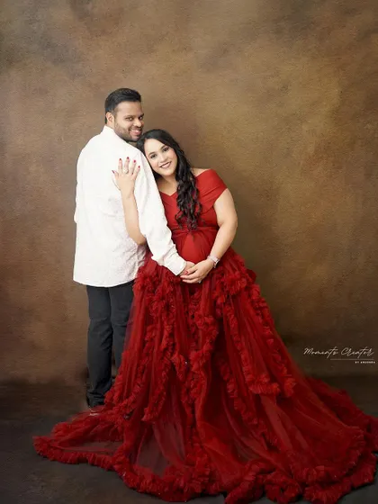 A tender and loving embrace. The mom-to-be leans back against her partner, creating a portrait that speaks of trust, support, and shared joy.