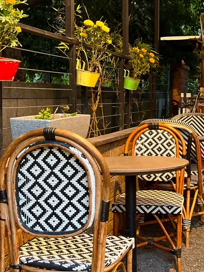 My outdoor seating area is perfect for enjoying a sunny day. The colorful pots and stylish chairs create a cheerful atmosphere.
