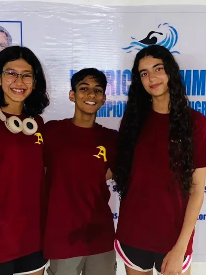 Three of my champion swimmers, all smiles after a successful competition. The bond they share as teammates is a key part of our academy's culture.