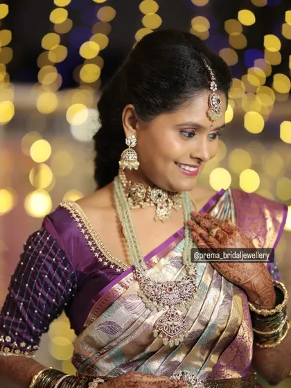 A close-up of the client, highlighting the details of her makeup and the intricate design of the choker and haram set.