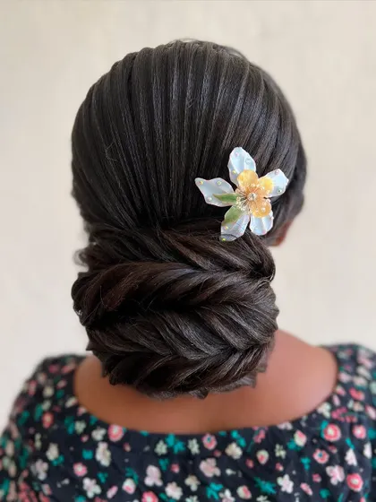 Another angle of the fishtail braided bun, highlighting the clean lines and the beautiful texture of the braid.