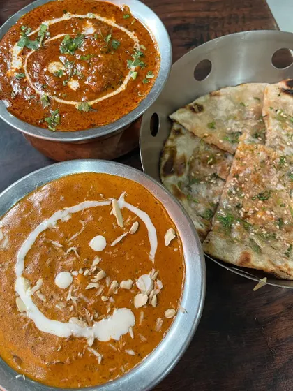 A collection showing the variety of our curries, from the preparation of Chicken Tikka Masala and smoky Kadai Paneer to finished bowls of Palak Paneer, Jeera Aloo, and Chicken Kadai. Each dish is prepared fresh and served hot.