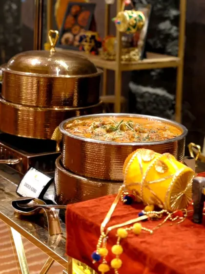 Another angle of our luxurious buffet setup. The gleaming copper serveware and thematic decor add a touch of royalty to the dining experience.