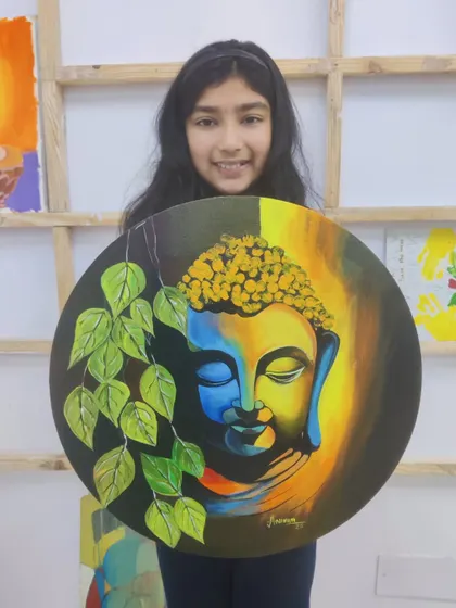 A serene Buddha painting on a round canvas, beautifully executed by one of our young students. Our classes often explore spiritual themes, providing a calm and meditative experience.