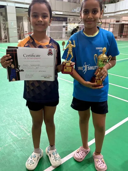 Two of our Racket Rider Tournament winners, Shristi and Swati, holding their certificates and trophies. It is wonderful to see their hard work translate into success.