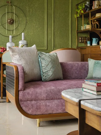 A custom sofa in a mauve fabric, adding a soft touch to the eclectic living space.