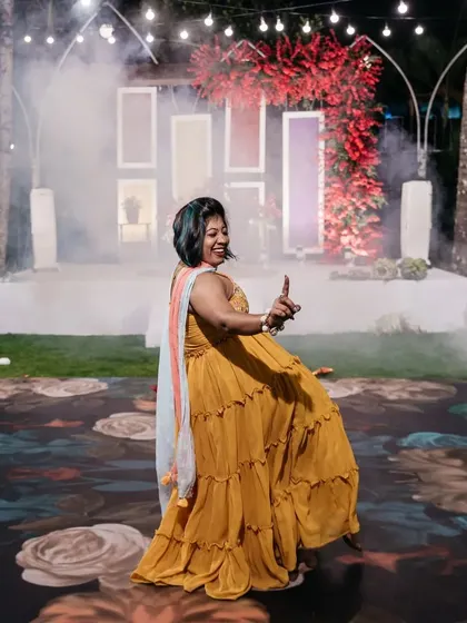 A guest enjoys the custom-printed floral dance floor. This unique detail added a splash of color and artistry to the Sangeet, making the dance area a central design feature.