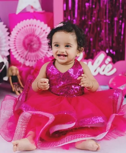 A joyful expression from our little Barbie girl. The vibrant pinks and shiny details make these photos pop with energy and fun.