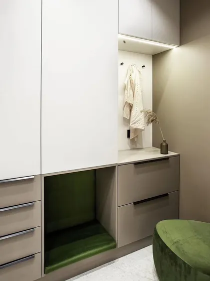 A custom-designed entryway unit with a seating nook, drawers, and a coat-hanging space. This all-in-one solution is perfect for keeping a family's entryway organized.