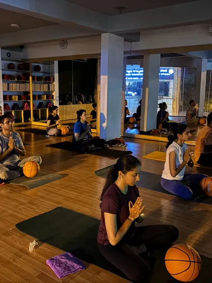 A moment of calm and focus during our basketball yoga class. Even with unconventional props, the essence of mindfulness remains.