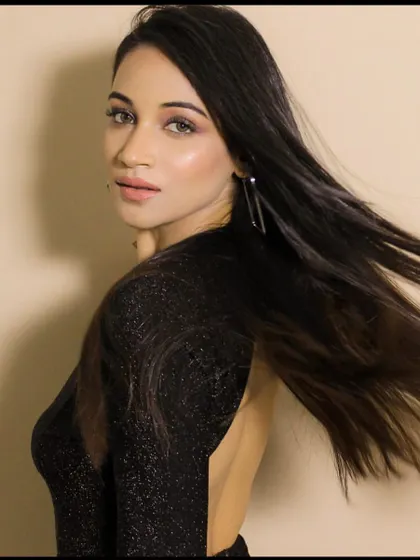 A glamorous party look with a classic little black dress. The makeup is all about glowing skin and defined eyes, with hair that has lots of movement.