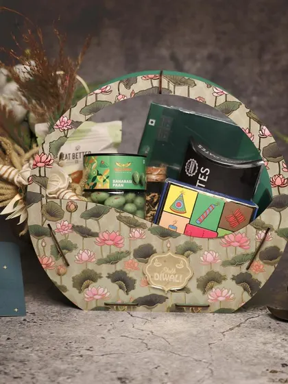 A lotus-themed basket for Diwali, filled with green-themed snacks and treats. The design is both traditional and elegant, perfect for celebrating the festival.