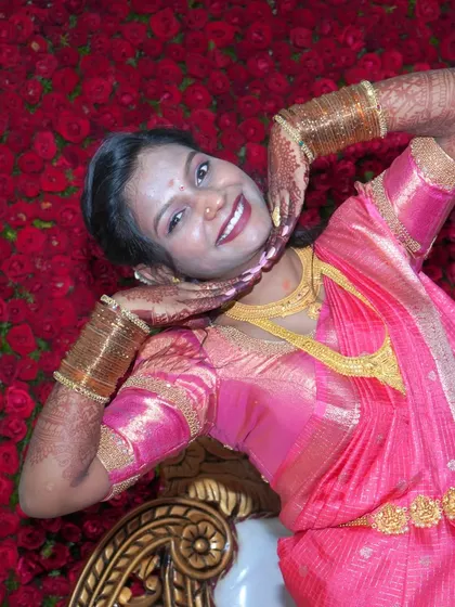 A fun and playful pose against a vibrant floral backdrop at a reception. I encourage clients to be themselves, which results in photos that are full of personality.