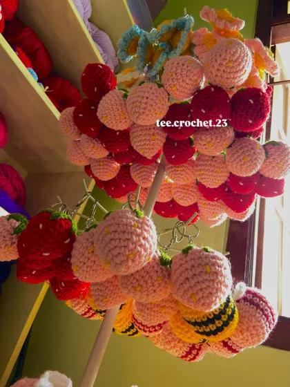 A fun shot of my strawberry and bee keychains hanging on a display stand. I offer these popular designs in different colors for wholesale orders.