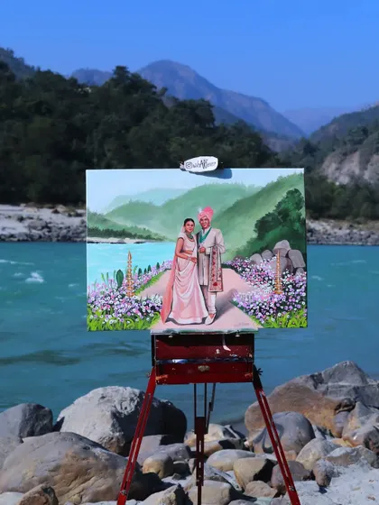 A dreamy wedding painting set against the flowing Ganga river in Rishikesh. The natural beauty of the location became a central part of this couple's painted memory.