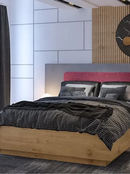 A close-up of the bed in the earthy-toned room, showing a pop of pink in the headboard for an unexpected touch of color.