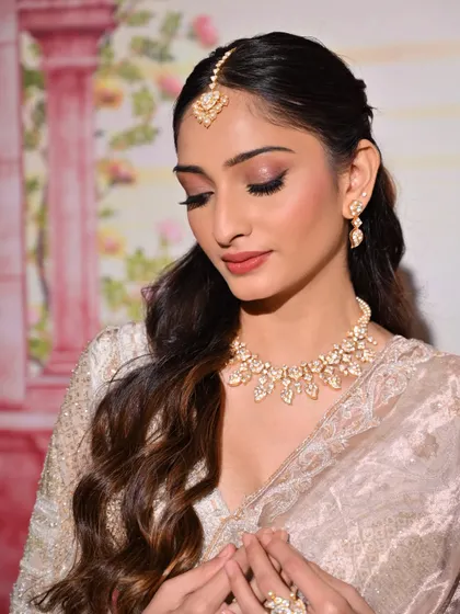 A detailed shot of the eye makeup for this soft glam look. The winged liner and full lashes open up the eyes, while the subtle shimmer adds a touch of elegance.