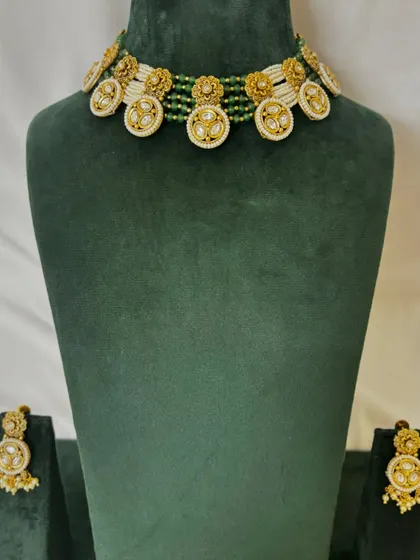 A full view of the unique floral motif choker with matching earrings. This rental set is perfect for adding a touch of elegance to your look.