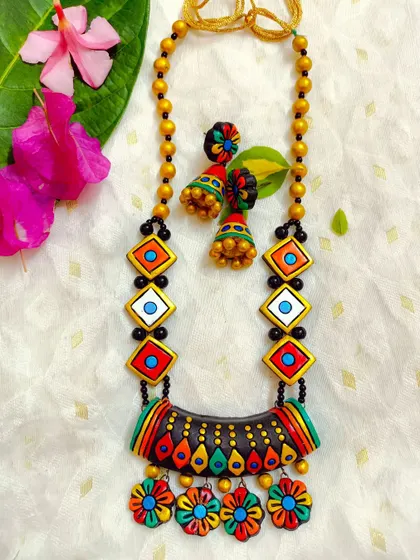 This vibrant and unique necklace is perfect for the festive season, especially Navratri. The combination of geometric and floral elements makes it a standout piece.