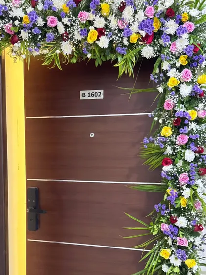 This is a full view of a lush door decoration, showing how it frames the entrance. The colors are chosen to stand out and create a grand, welcoming statement for any event.