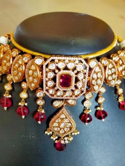 A beautiful Kundan choker with a ruby-red center stone and matching bead drops. This is an example of the kind of custom piece I can create for you.