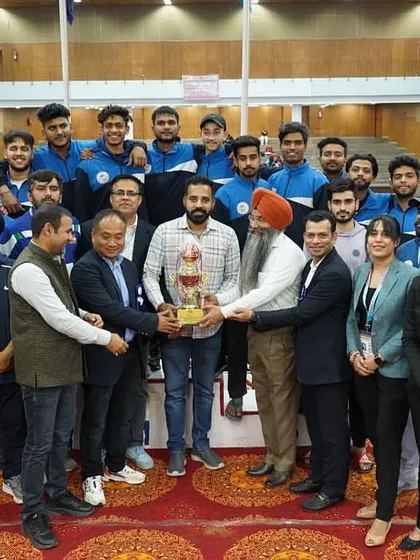 Presenting a trophy to a winning team at the university championships. Recognizing the effort and success of young athletes is a highlight of my role.