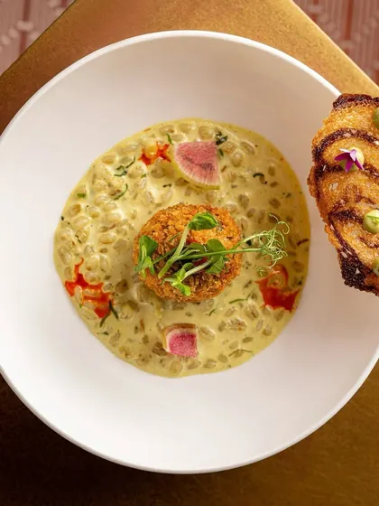 From our Christmas feast, a green pea kofta in a cauliflower and barley stew, served with a fennel butter toast. A hearty and elegant vegetarian main course.