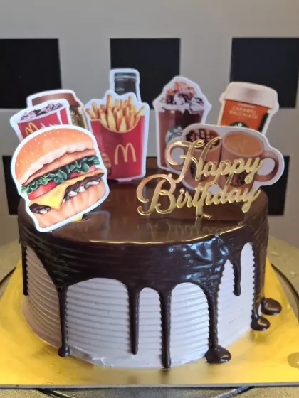 I can create cakes based on any fun theme, even your favorite food spots. This chocolate drip cake was customized with McDonald's and Starbucks toppers for a unique and modern birthday celebration.