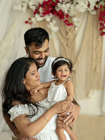 A duplicate of image 40, a happy family of three. The daughter's joyful laugh is infectious, making this a standout family portrait.