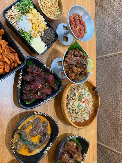 An overhead shot of some of our most popular dishes, ready to be shared. This spread includes fried rice, pork curry, and other Naga specialties.