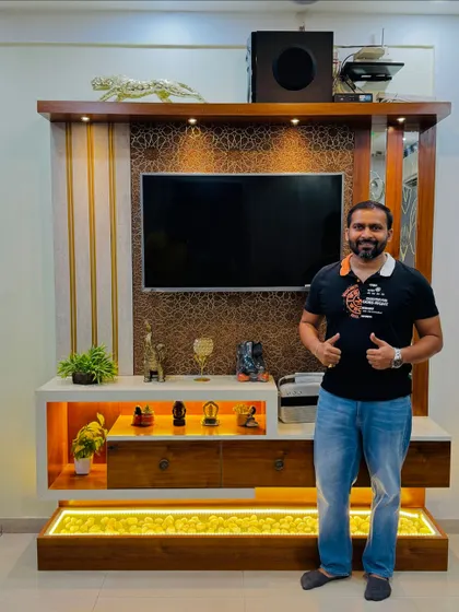 Here I am with a happy client's new TV unit. Seeing the satisfaction on their face is the best part of my job.