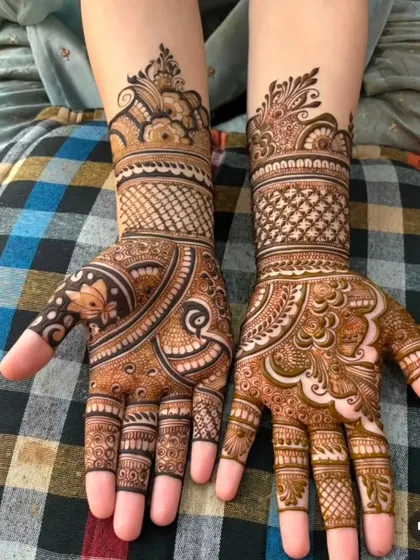 This design combines different techniques, including delicate net patterns (jaali), bold floral work, and leafy vines for a modern yet intricate feel.