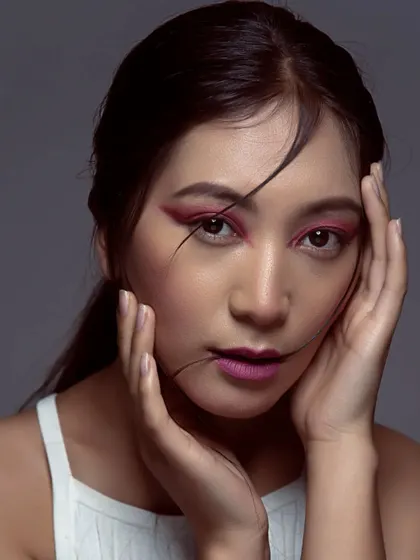 A close-up on the artistic pink eye makeup. I kept the rest of the face clean and fresh to let the eyes be the main focus, demonstrating a bold yet balanced approach to editorial beauty.