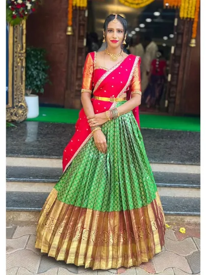 A classic pose showcasing the timeless elegance of the red and green langa voni.