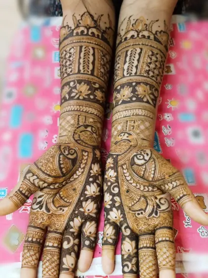 A graceful design featuring peacocks and lotuses, two of the most beloved motifs in Indian bridal art. The patterns flow beautifully from the palm to the elbow, creating an elegant and traditional look.