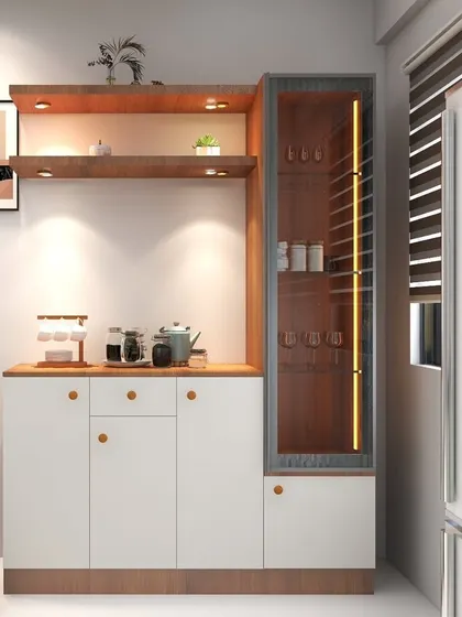 A stylish crockery and bar unit designed for a 2BHK in Channasandra. It features open shelving with accent lighting and a glass cabinet for displaying glassware.