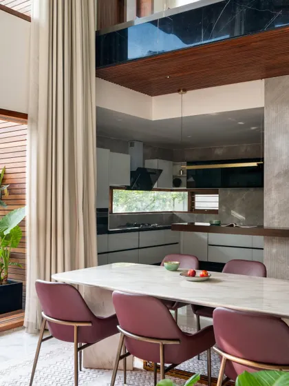 The dining area in the Timber Edge project, situated in a double-height space next to a small courtyard. This design ensures the room is filled with natural light.