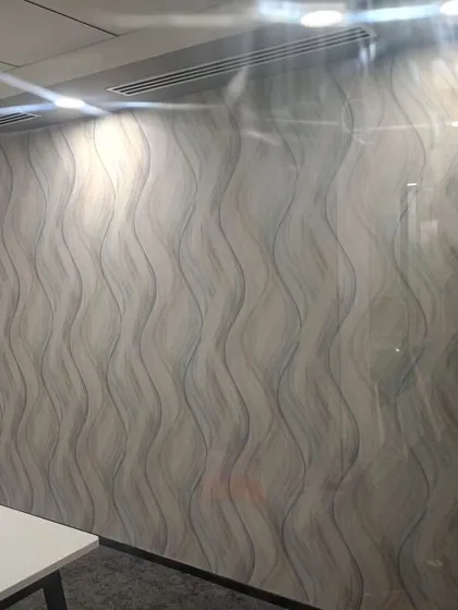 A wallpaper with a wavy, linear abstract pattern.