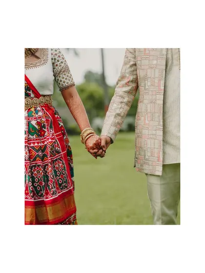 A simple, yet powerful detail shot of the couple holding hands. It symbolizes their connection and the journey they are beginning together.