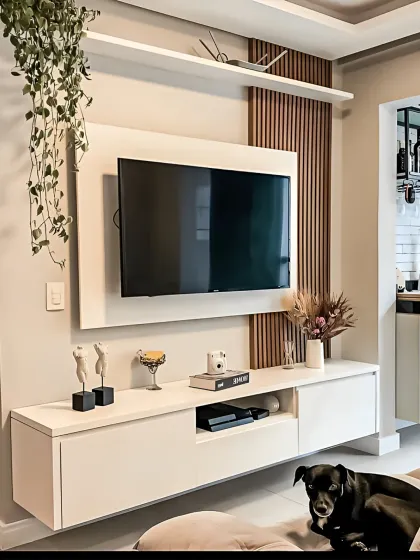 A clean and contemporary floating TV unit in all white. The design is accented with a section of vertical wood slats and a simple top shelf, creating a minimalist look that is both stylish and functional.