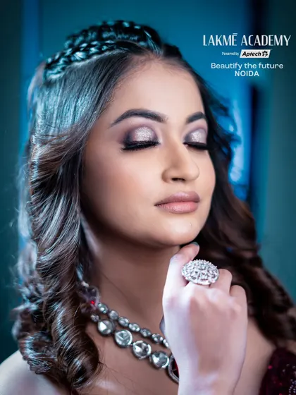 A detailed close-up of a soft glam eye. The silver shimmer on the lid and the subtle winged liner create an elegant and sophisticated look that our students master.