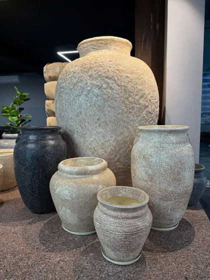 A collection of our rustic, textured pots in various shapes and sizes. These are perfect for creating a warm, earthy, and organic feel in your garden or home.