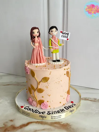 Sweet endings and new beginnings! A fun "Game Over" cake to say goodbye to single days, featuring custom bride and groom toppers.