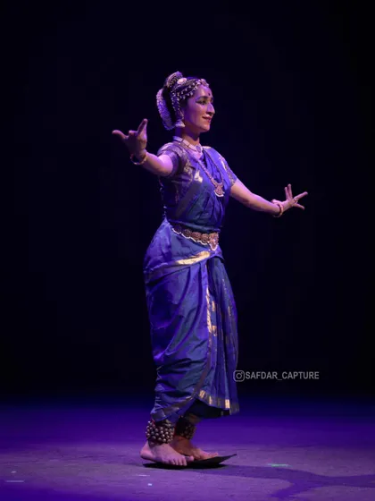 Dancing on the brass plate, seen from the side. This angle shows the precision required to maintain balance while moving.