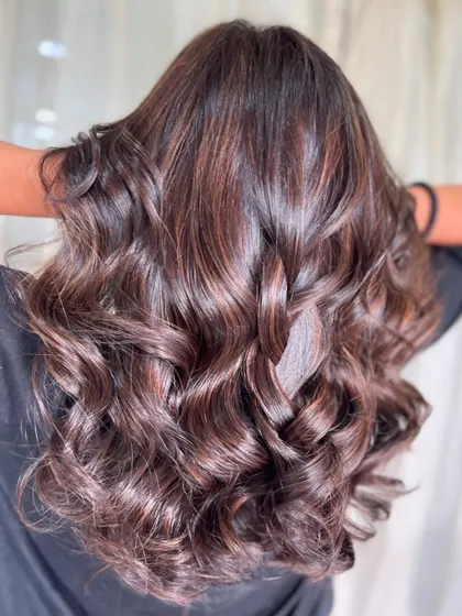 The magic of brown. This image showcases a beautiful, curly style with rich color, ready to complement any vibe.