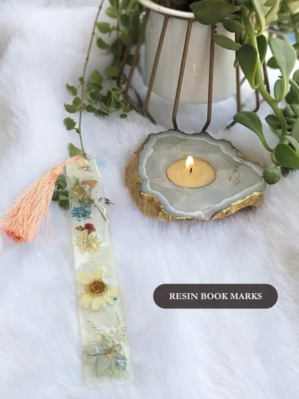 A custom resin bookmark with preserved flowers. This is a unique and thoughtful item for corporate gift hampers, event giveaways, or as a special thank you to clients and team members.