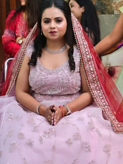 A full-length seated shot of the bride in her lilac gown, looking like a princess.