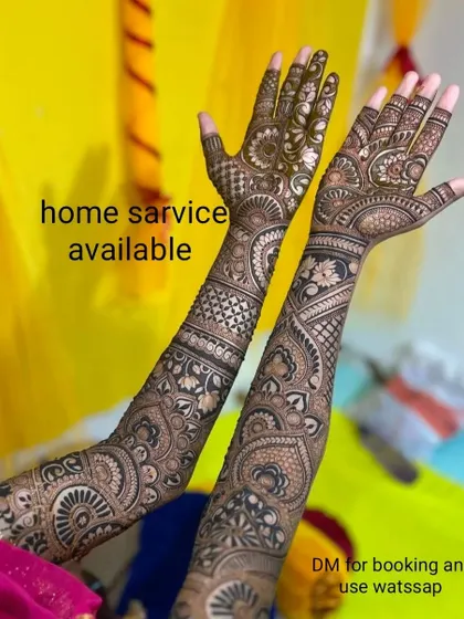 A full bridal design with intricate patterns covering the arms. I offer all styles, including bridal, Arabic, and 3D mehndi, with home service available.